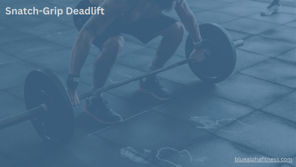 Close-up of a person positioning for a Snatch-Grip Deadlift, hands wide on the barbell, back straight, and knees slightly bent, preparing for optimal back and hamstring engagement.